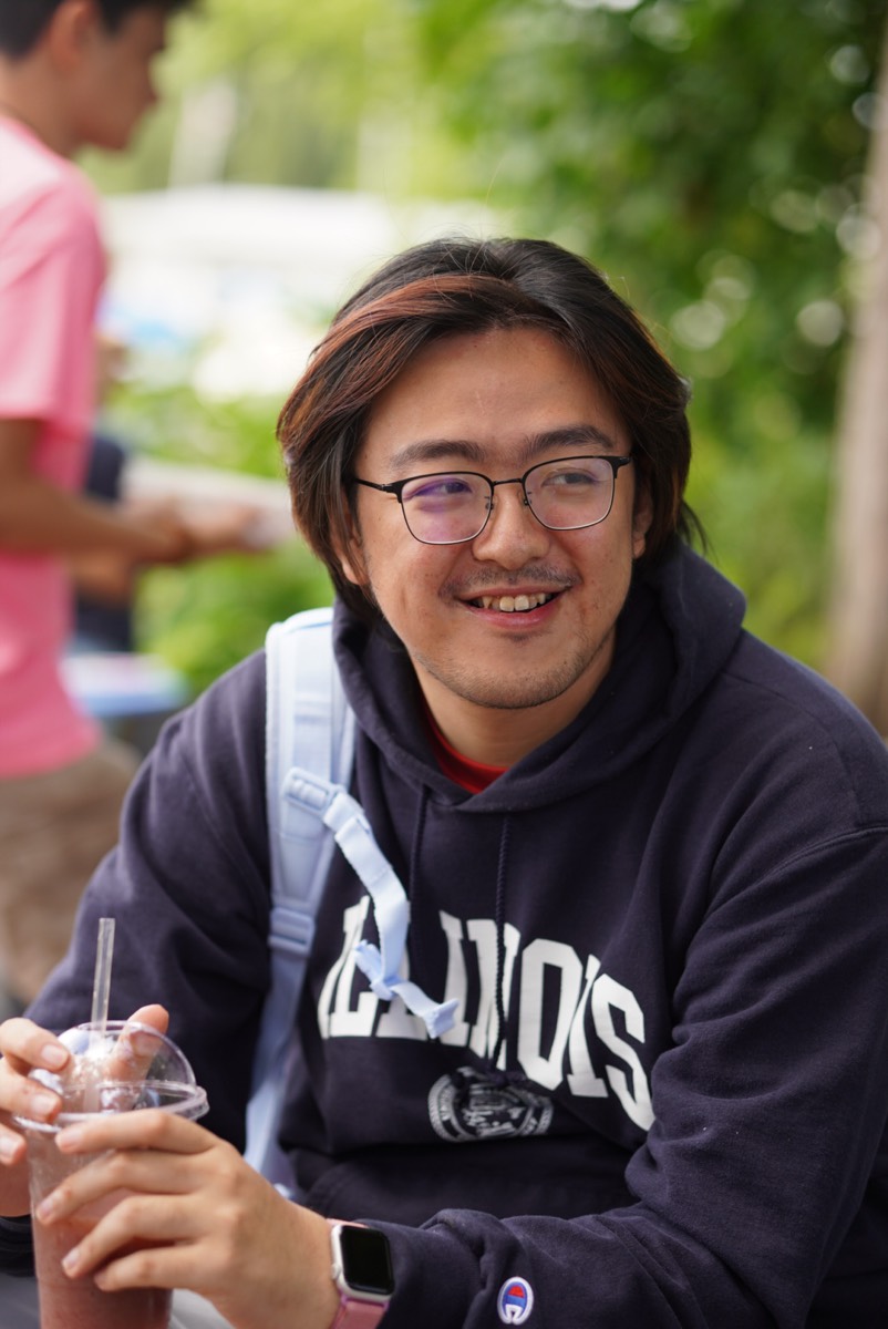 Shengmiao Jin outdoors in an Illinois hoodie